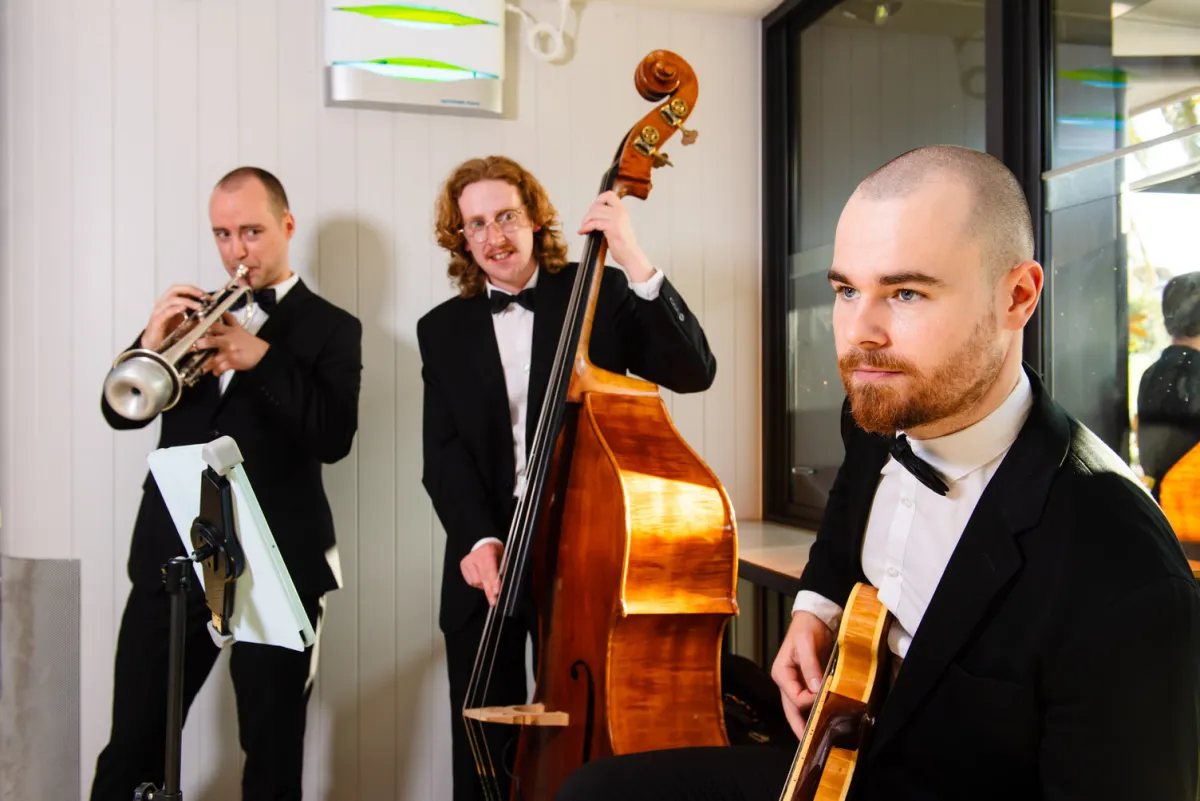 Hugh Parsons performing with double bass and guitar in a cocktail trio
