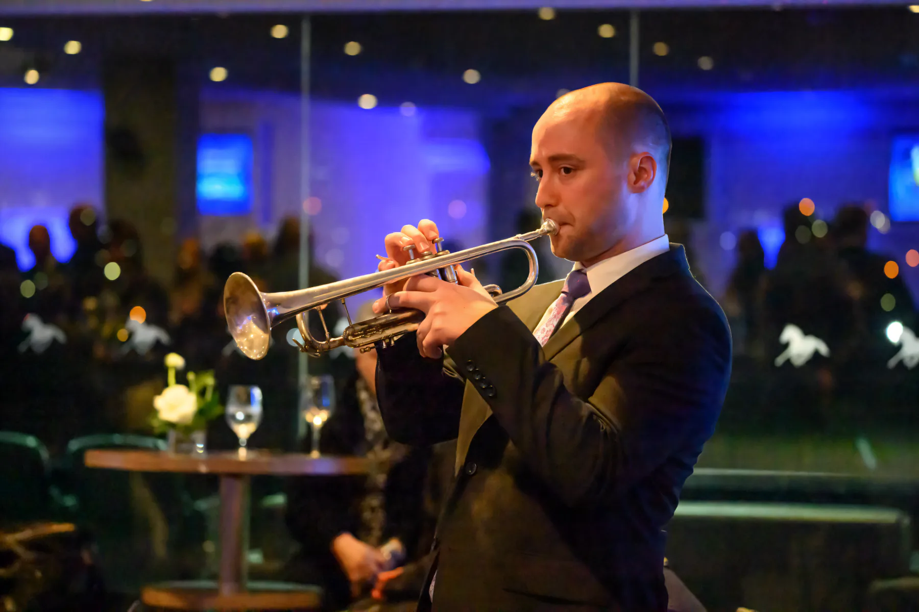 Hugh Parsons playing trumpet in a softly lit venue
